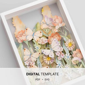 May include: A framed paper art piece with a layered floral and butterfly design. The artwork features cream and lavender butterflies, and peach, yellow, and white flowers. The text "DIGITAL TEMPLATE" is visible at the bottom of the frame.