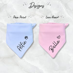 May include: Two personalized dog bandanas, one light blue with a paw print and the name "Alfie" and one pink with a heart and the name "Bella".