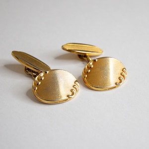 Vintage Gold-Tone Oval Cufflinks with Decorative Scrollwork and Textured Stripes