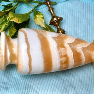 Vintage magnificent hand sculpted Egyptian vase made of alabaster in a beautiful white and honey waves in a classical form