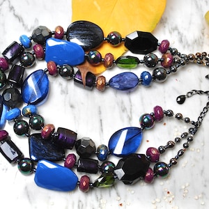 Statement necklace multi-stranded with extra large beads in midnight blue and purple colours