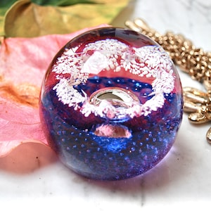 Caithness numbered handblown vintage paperweight in blue and pink with a floating white garland, made in Scotland