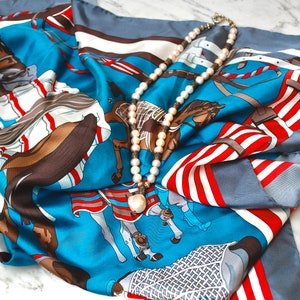 Luxury woman square scarf from pure silk with equestrian pattern in rich marine blue, ruby red and ice white colours