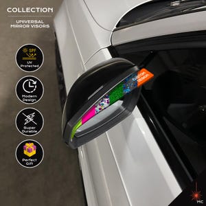 May include: Black universal mirror visor with a colorful design. The visor is attached to a white car. The text on the visor says "CUSTOM DESIGN". The image also includes icons for UV protection, modern design, and durability.