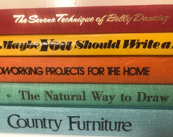 Colorful stack of vintage “how to” books. Learn to draw, build furniture or belly dance.