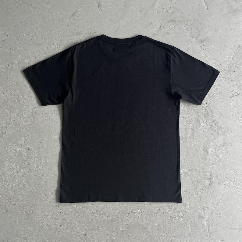 May include: A plain black t-shirt with short sleeves.