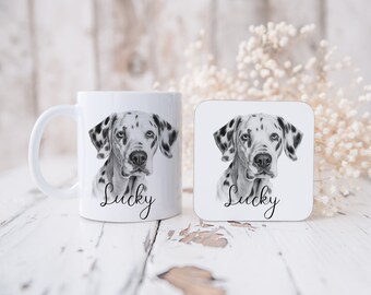 May include: White ceramic mug and square coaster featuring a black and white Dalmatian dog portrait. The word "Lucky" is written in a script font below the dog's image. The mug has a curved handle.