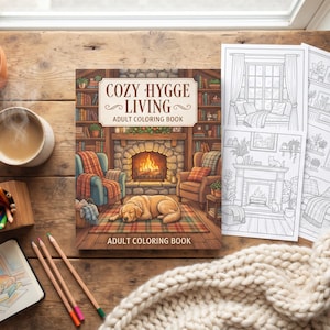 May include: A coloring book titled Cozy Hygge Living Adult Coloring Book featuring a fireplace, armchairs, and a sleeping dog on the cover, accompanied by three black and white coloring pages, colored pencils, and a sketchbook.
