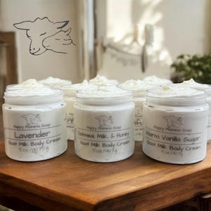 May include: Four glass jars of goat milk body cream with labels that read "Lavender", "Oatmeal, Milk, & Honey", "Warm Vanilla Sugar", and "Happy Momma Soap". Each jar contains 5 oz (141.75 g) of cream.