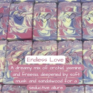 May include: Artisan soap bars with a heart design carved into the top. The soap features a swirl of pink, purple, and cream colors. The text "Endless Love" is displayed on the image, along with a description of the scent.