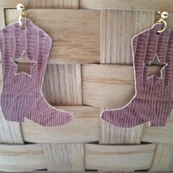 Earrings: This is a pair of brown leather cowboy boots. with a star cutout. They are handmade and lightweight.