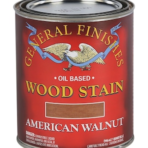 May include: A can of General Finishes oil-based wood stain in American Walnut. The can is red with a gold eagle and the text "General Finishes" in a white circle. The can is labeled "Oil Based" and "Wood Stain" in white text. The can is 1 quart (946 ml).