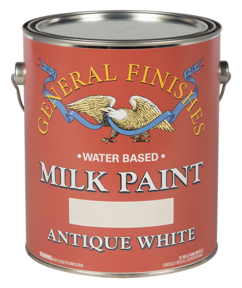 May include: A red paint can with a white label. The label says "General Finishes" in a black script font, "Water Based" in black, "Milk Paint" in black, and "Antique White" in black. The can is 1 gallon.