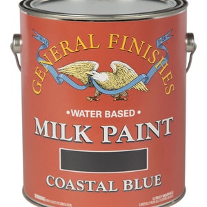 May include: A gallon can of General Finishes Milk Paint in Coastal Blue. The can is red with a white eagle and blue ribbon. The text "Since 1928" is on the can.