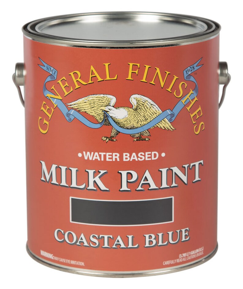 May include: A gallon can of General Finishes Milk Paint in Coastal Blue. The can is red with a white eagle and blue ribbon. The text "Since 1928" is on the can.