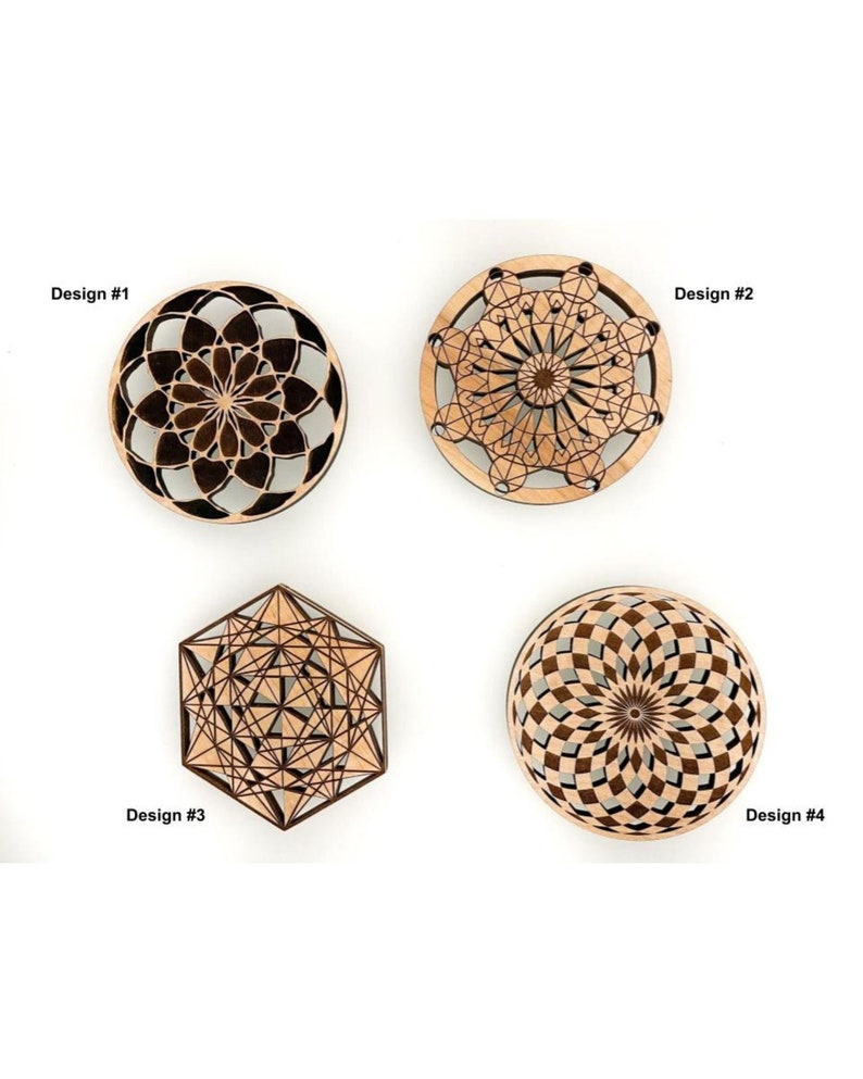 May include: Four wooden decorative designs are displayed against a white background. Design #1 is a dark brown circular floral pattern. Design #2 is a light brown circular design. Design #3 is a geometric hexagon. Design #4 is a circular design with a brown and gray pattern.