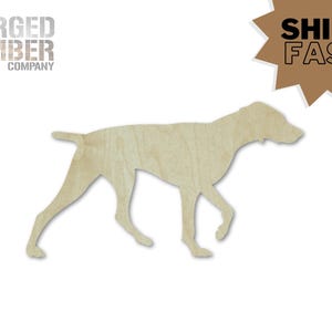May include: A wooden cutout of a dog in a walking pose. The dog is light brown and has a smooth surface. The text "FORGED TIMBER COMPANY" is in the upper left corner. A brown starburst with the words "SHIPS FAST" is in the upper right corner.