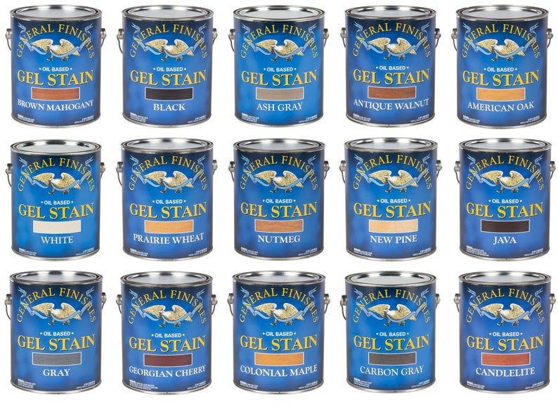 May include: A collection of 15 paint cans, each with a different color of General Finishes Oil-Based Gel Stain. The cans are arranged in three rows of five, with the colors in each row being similar. The colors include Brown Mahogany, Black, Ash Gray, Antique Walnut, American Oak, White, Prairie Wheat, Nutmeg, New Pine, Java, Gray, Georgian Cherry, Colonial Maple, Carbon Gray, and Candlelite.