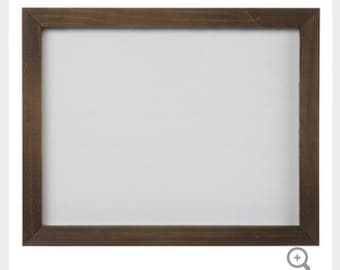 May include: A brown wooden picture frame with a white mount and a white background.