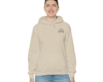 May include: A beige hoodie with a small embroidered design on the left chest. The design features three anchors and the text "Thirty Knots".