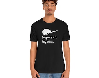May include: A black t-shirt with a white graphic of a squirrel holding a knife. The text "No spoons left. Only knives." is printed below the graphic.