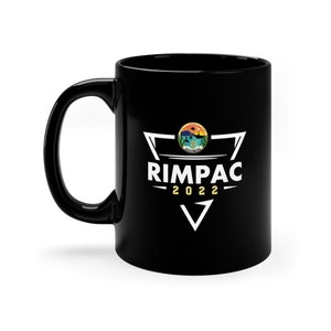 May include: Black ceramic mug with a white triangle design featuring the text "RIMPAC 2022" and a circular graphic of a seal with a sunset and a ship.
