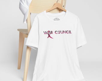 May include: White t-shirt with a pink graphic that says "War Council".