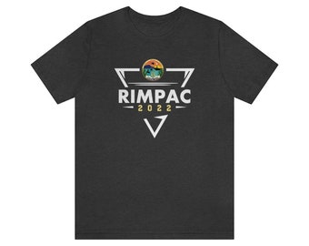 May include: A dark heather grey t-shirt with a white triangle graphic featuring the text "RIMPAC 2022" and a circular graphic of a sunset over water.