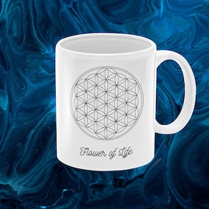 May include: White ceramic mug with a black Flower of Life design and the text "Flower of Life" printed on the bottom.