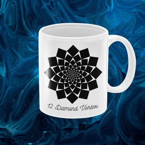 May include: White ceramic mug with a black and white geometric design of a 12-pointed star. The text "12 Diamond Vortex" is printed on the bottom of the mug.