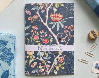 May include: A blue notebook with a floral design and the text "LAURA SOWERBY NOTEBOOK" on the front.