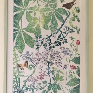 May include: A framed print of a botanical illustration featuring a variety of green leaves, flowers, and a butterfly. The print is on a white background and has a light green frame.