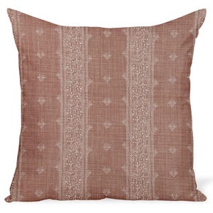 May include: A square throw pillow in a muted terracotta color featuring a textured fabric appearance. The design includes vertical bands of intricate white floral patterns alternating with columns of small, repeating white heart-shaped motifs.