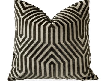 May include: A black and white geometric patterned pillow cover. The pattern is a repeating design of stripes and hexagons.