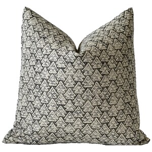 May include: A decorative throw pillow with a black and white pattern of stylized pine trees. The pillow is made of a soft, textured fabric.