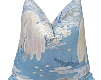 May include: A blue and white pillow with a Japanese-inspired design featuring a boat, mountains, and cherry blossoms.