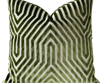 May include: Green and white geometric patterned throw pillow with a velvet texture.