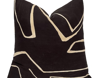 May include: Black and white geometric patterned throw pillow with a cream colored background and black abstract lines.