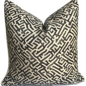 May include: Black and white geometric patterned throw pillow with a maze-like design.