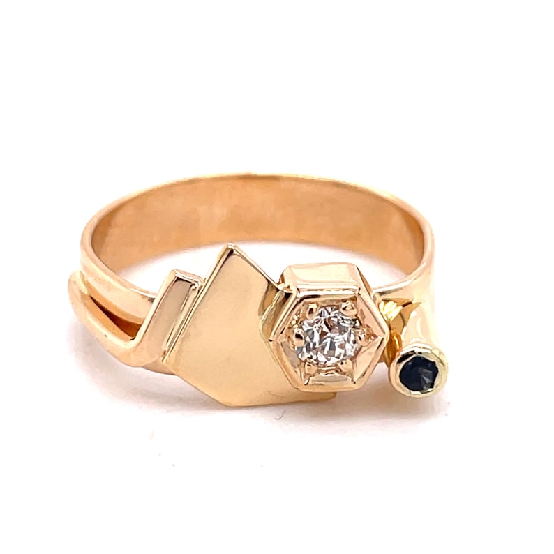 May include: Gold ring with a geometric design featuring a single diamond and a black stone.