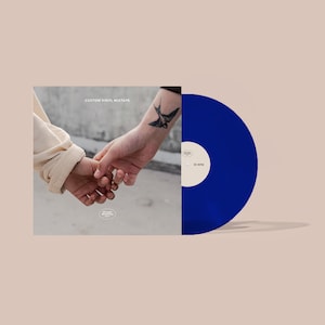 May include: A custom vinyl mixtape with a blue record. The album cover features two hands holding each other, with the text "CUSTOM VINYL MIXTAPE". The record label says "Mirage Romantics" and "33 RPM".