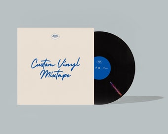 May include: A black vinyl record with a blue label is partially visible next to a cream-colored album cover. The album cover has the words "Custom Vinyl Mixtape" in blue script. The record is a 33 rpm.