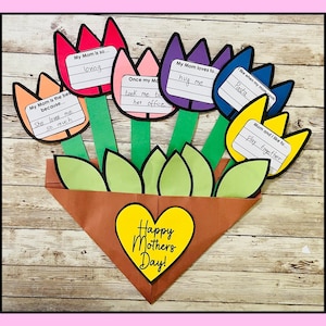May include: A colorful paper craft bouquet of tulips with handwritten messages for Mother's Day. The tulips are in a brown pot with green leaves and a yellow heart that says "Happy Mothers Day!"