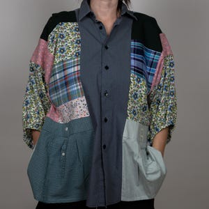 May include: A patchwork button-up shirt with a variety of floral, plaid and solid patterns in shades of blue, green, pink and black.