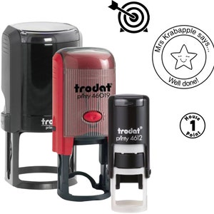 May include: A selection of self-inking stamps, including black and red "Trodat" brand stamps. The image also features a target symbol, a star with "Well done!", and a stamp with "House 1 Point".