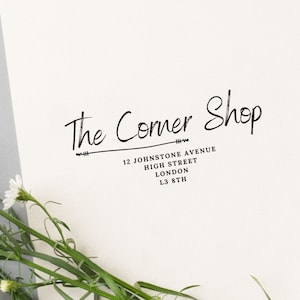 May include: Black and white stamp with the text "The Corner Shop" and the address "12 Johnstone Avenue, High Street, London, L3 8TH".