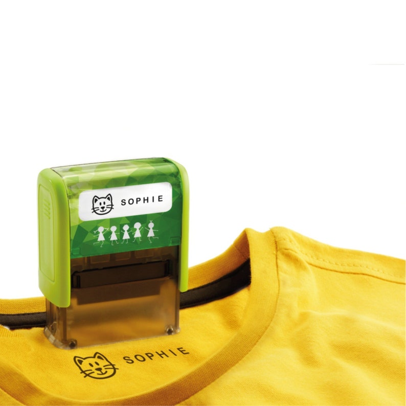 May include: Green and clear self-inking stamp with a cat and the name "Sophie" on a white label. The stamp is being used to stamp a yellow t-shirt with the same design.
