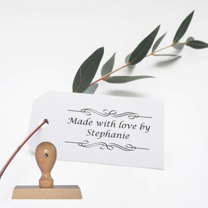 May include: Wooden stamp with a white label that reads "Made with love by Stephanie" with decorative flourishes above and below the text.