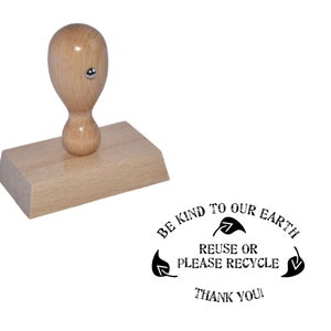 May include: Wooden stamp with a handle and a rectangular base. The stamp reads "Be kind to our earth. Reuse or please recycle. Thank you!" with a leaf design.