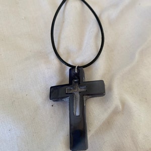 Cross on black strap
